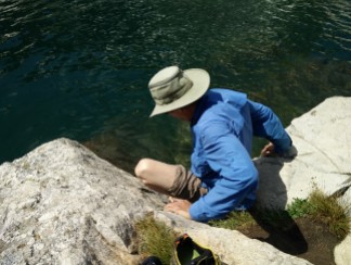 Jim testing the water temperature of Lake Solitude - um, pretty darn cold!